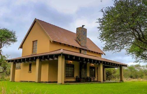 Private chalet exterior with thatched roof
